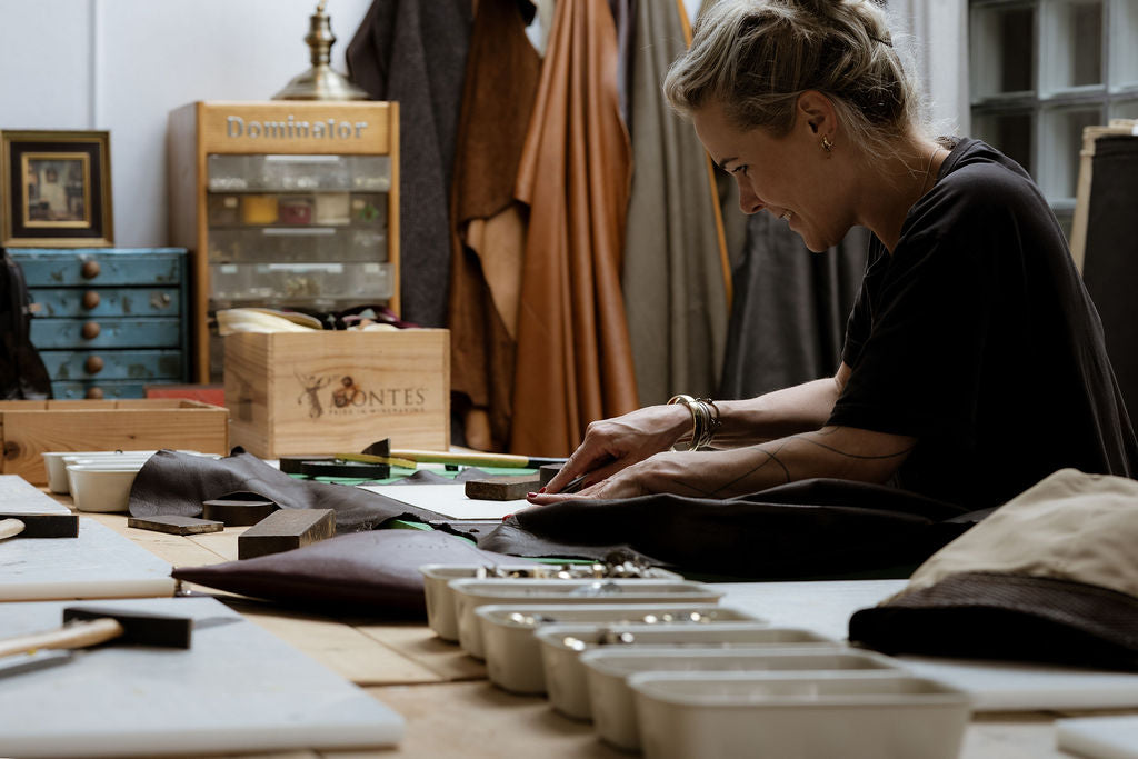 Juul working in Atelier Jume - handcrafted leather accessories